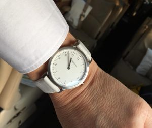 Predial Uhr im Einsatz. Edelstahlgehäuse mit weißem Zifferblatt und Lederband.